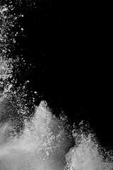 Bizarre forms of white powder explosion cloud against black background.White dust particles splash.