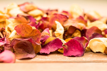 Dried Rose Petals Spread on a Wooden Surface