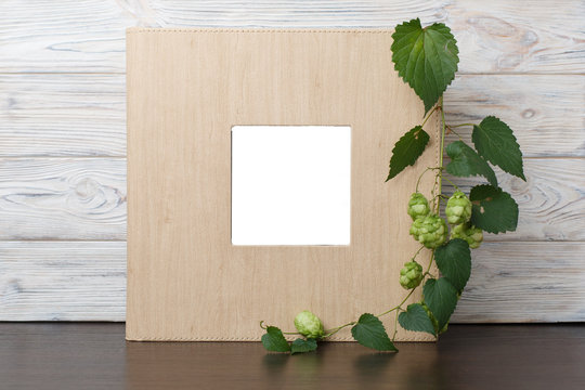 photo book with  leather cover.
Wedding photo album.
Beige photobook on a wooden background.
photo album with insert

