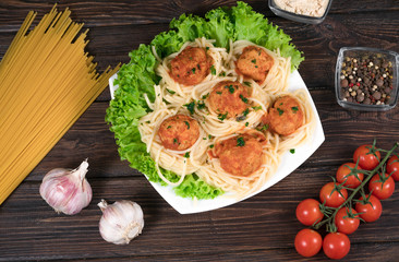 Spaghetti bolognese pasta with tomato sauce, vegetables and minced meat - homemade healthy Italian pasta on a rustic wooden background. View from above.