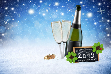 happy new year 2019 ice blue snow night stars sky bokeh background champagne bottle glass cork  blackboard greeting card