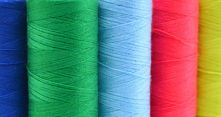 Sewing threads multicolored background closeup