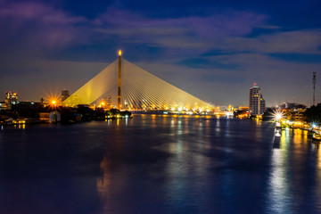 Landscape Rama 8 Bridge at night. It is a bridge used for transportation across the Chao Phraya River. The landmark of Bangkok Thailand.