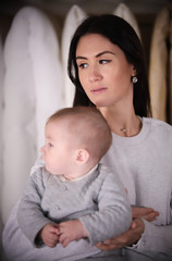 Young happy family on shopping. Young mother holding a baby