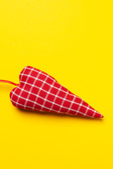 handmade red fabric heart on yellow background, Flat lay, top view, copy space