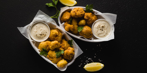 banner of Fried cauliflower in batter with a savory sauce of cashew nuts. healthy vegan fast food. Baked Buffalo Cauliflower 