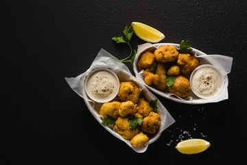 Fried cauliflower in batter with a savory sauce of cashew nuts. healthy vegan fast food. Baked Buffalo Cauliflower 