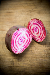 red beet cut in half on a wooden cutboard