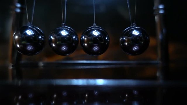 Newton's pendulum. Slow motion shot of a Newton's Cradle 480fps