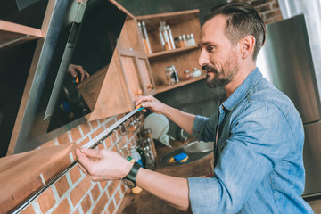 It is correct. Delighted young male person standing in semi position while working with pleasure
