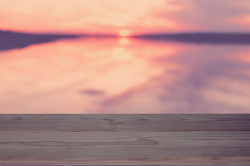 Fototapeta na wymiar empty table on the sunset lake background