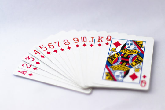 Playing Cards fanned out: Suit of Spades, Clubs and Diamonds fanned out over white background. Gambling, Poker, Win, Lose, Chance, Gambling, Money, Red, Black, Jack, Queen, King