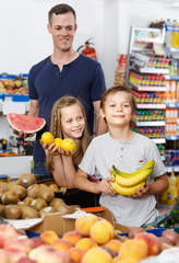 Kids choosing fresh fruits during, family shopping in grocery store
