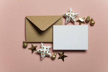 Christmas card template mock up. Blank card with envelope on pink background