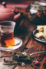 Spoonful of raspberry herbal tea and ready tea in armudu glass