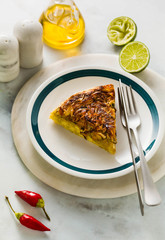 savory salty  Upside-Down pie from white cabbage, carrots and onions. gluten free no eggs , with chickpea flour. family breakfast or party snack on a white marble table