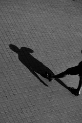 shadow of human on a brick floor - monochrome
