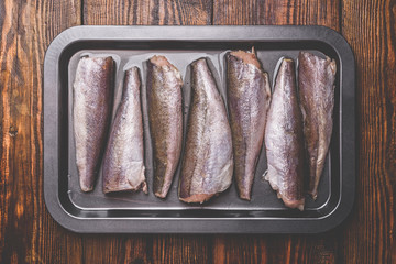 Hake carcasses on baking sheet
