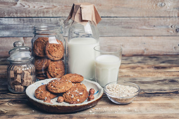 Oatmeal cookies and milk on a wooden background