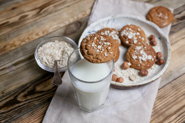 Oatmeal cookies and milk on a wooden background