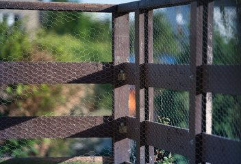 Wooden terrace with a metal grid