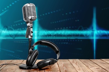 Retro style microphone and headphones on  background