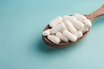 multi colored and white pills are on the table