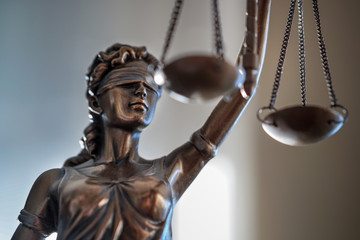 Statue of Justice with scales in lawyer office. Legal law, advice and justice concept