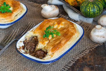 Steak and mushroom pie on rustic wooden backgournd