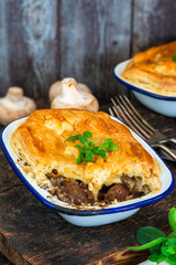 Steak and mushroom pie on rustic wooden backgournd
