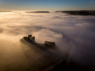 Chateau Beynac in fog in the early morning Perigord Noir Dordogne France