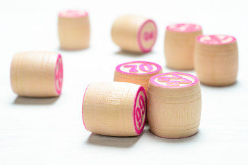 Fototapeta na wymiar Board game lotto or bingo. Some wooden lotto barrels with numbers, close-up. Vintage Game.