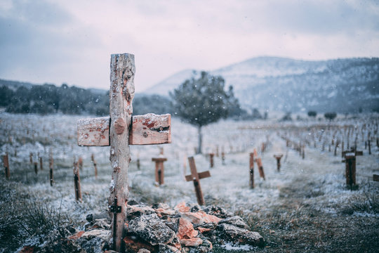 Christian cross in a cemetery in winter