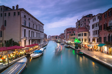 Night view on canale di cannaregio in Venice with passing by boat ,long exposure photo.