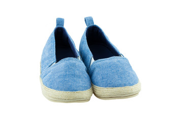Child fashion. A pair of blue denim child shoes isolated on a white background.