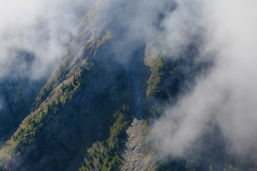 Steep cliff in French alps at summer time