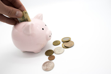 Pink piggy bank and money