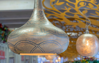 Metallic gold-plated lamp in oriental style with a soft glow.
