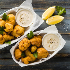 Fried cauliflower in batter with a savory sauce of cashew nuts. healthy vegan fast food. Baked Buffalo Cauliflower 