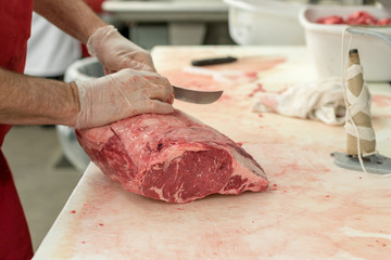 Butcher Carving Meat - 230874954