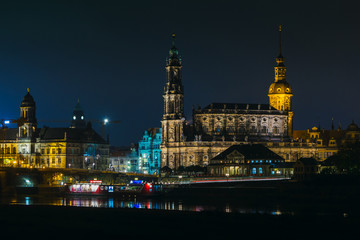 Fototapeta na wymiar View of the old town of Dresden at night with a view of water and the reflection of the city as well as, churches, towers and buildings. Elbe river. Germany. Saxony.