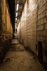 Fototapeta premium Endless floor in an abandoned, dirty cellar with tiled walls