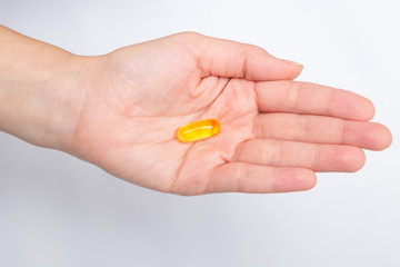 Nutrition. Healthy Lifestyle. Woman Holding Capsule With Fish Oil Omega-3. Supplements, Vitamins.