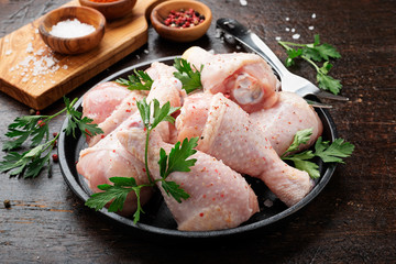 Chicken legs. Raw chicken legs with salt pepper and herbs.