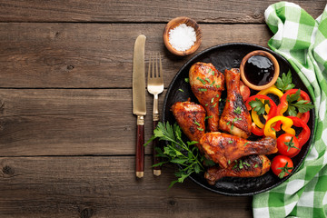 Grill chicken legs. Grilled chicken legs BBQ with sauce, parsley and tomato.