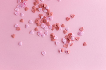Pink sugar hearts isolated on pink.