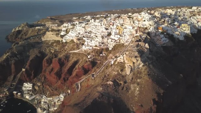 Byzantine Castle Ruins in Oia at sunset, aerial