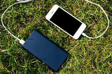 power Bank and phone on the grass