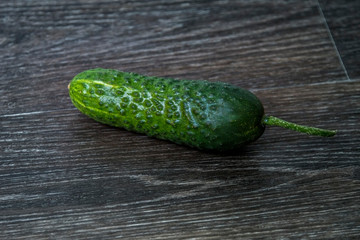 ripe cucumber lies on the table