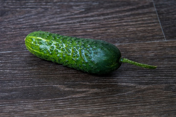 ripe cucumber lies on the table